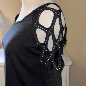 Black 3/4 length sleeve shirt with cut outs at the shoulders with crystals